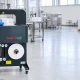 Advantages of a banding machine — operator feeding a stand alone machine