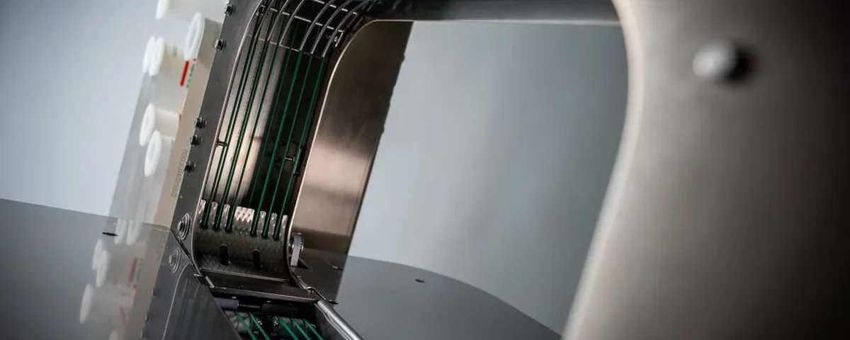 Banding machine uptime — the green belts inside the arch