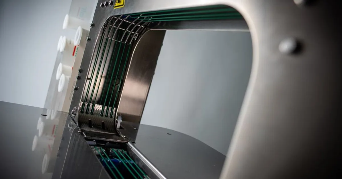 Close-up of the green belts inside the banding machine arch