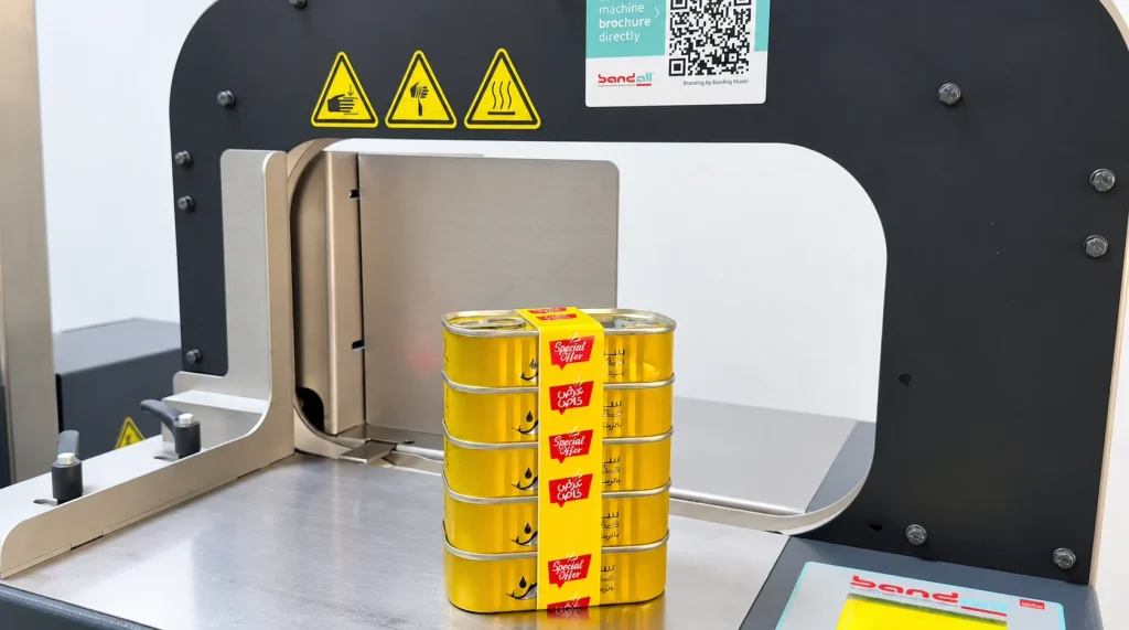 Home page tuna 3 in 1 banding featured v2 42 A stack of five yellow cans with a printed Special Offer band on a Bandall banding machine